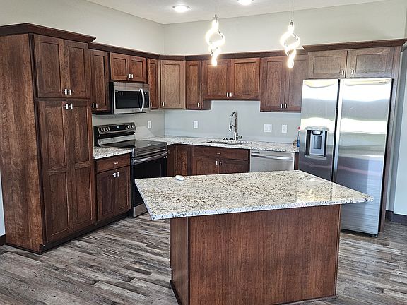 Kitchen with stainless steel appliances, granite, cherry cabinets.