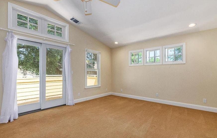 Large master bedroom with lots of natural lights and balcony