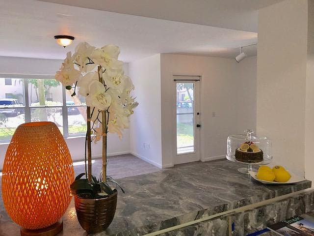 open floor plan, screened in patio with storage closet, pass thru has bar seating