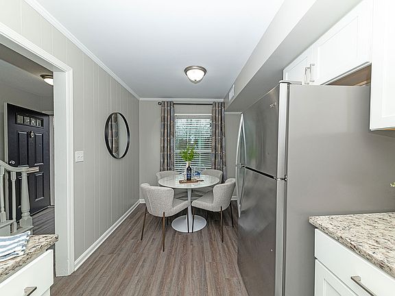 Dining area with hardwood-style flooring & overhead lighting
