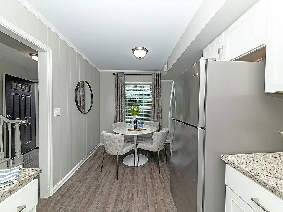Dining area with hardwood-style flooring & overhead lighting