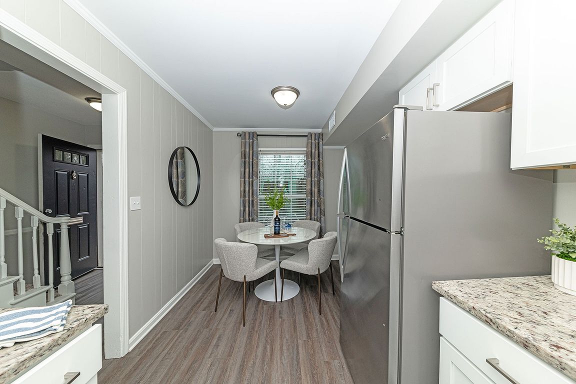 Dining area with hardwood-style flooring & overhead lighting