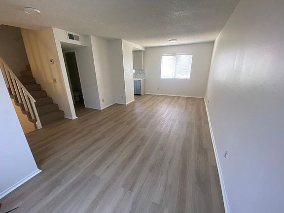 Living/dining area and half-bath. Stairway leads down to garage and up to bedrooms and bath.