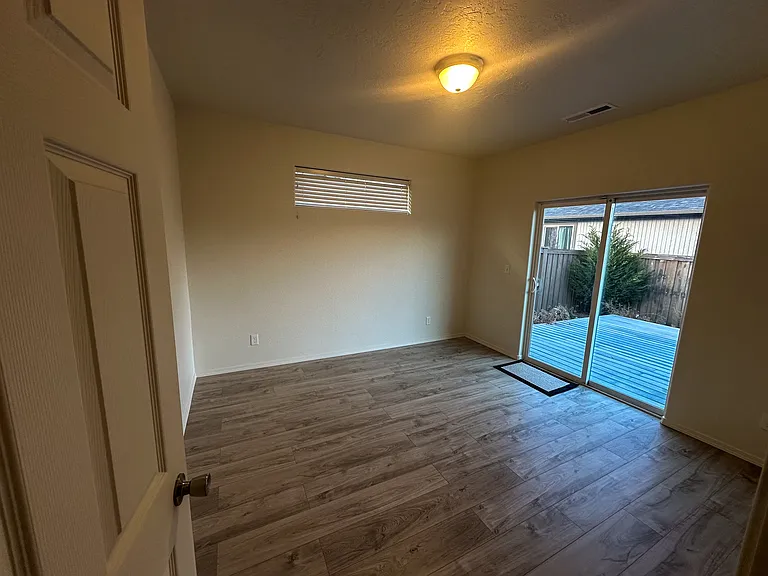 Master Bedroom with Trex Custom deck off sliding glass door. Custom Vertical blinds on order & will install within the next few weeks.