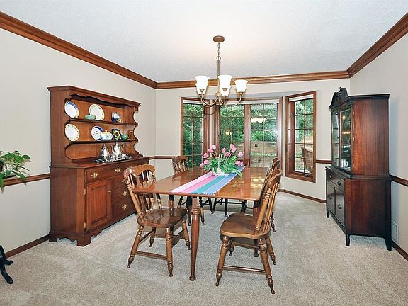 Formal dining room with bay window,natural wood&crown mold
