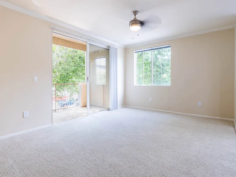 Carpeted Living Room with Balcony