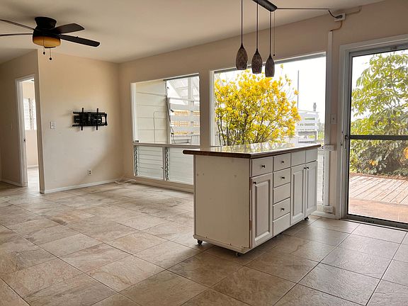 Kitchen island and living room. Entry door is on the right.