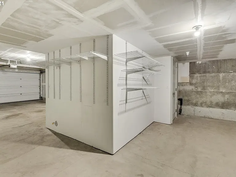 Large two car garage with enormous storage area in the back.