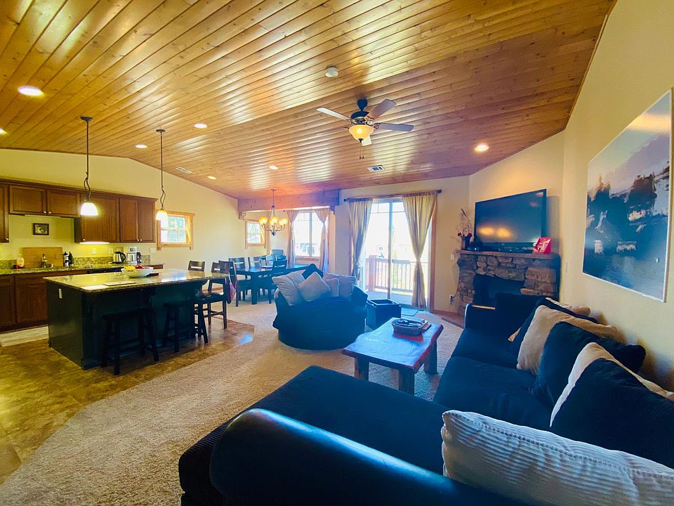 The great room: open kitchen with all SS appliances, granite counter top and big island. Living room with gas fireplace and balcony over looking the aspen trees and the quiet playground, dinning table seats 8 people.