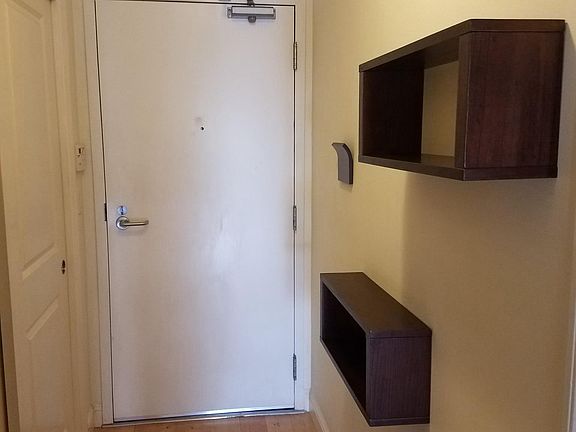 Front entrance with convenient wall mounted storage areas for keys, letters, etc.