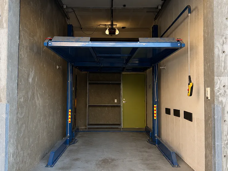 Garage with a commercial grade hydraulic car lift. Use the upper deck for another SUV or storage