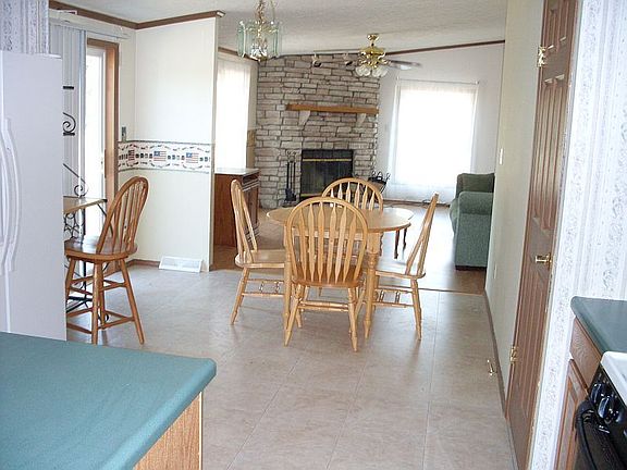 Main home
						:
						Kitchen into dining and den. Full rock fireplace.