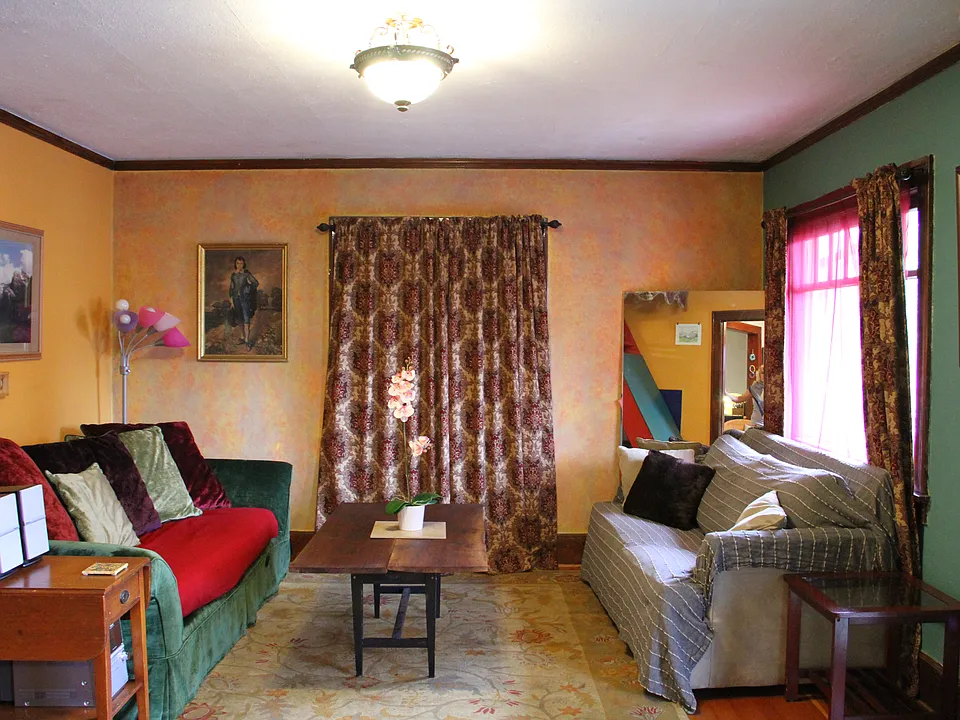 Comfy living room with large picture windows.