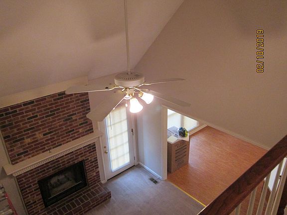looking over the upstairs railing to the fireplace