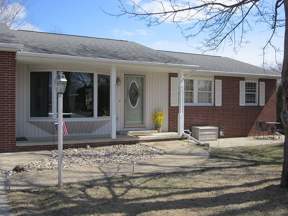 Front of house with custom brick walkway and patio