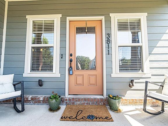 Front door leads into living space. Front porch has room for seating.