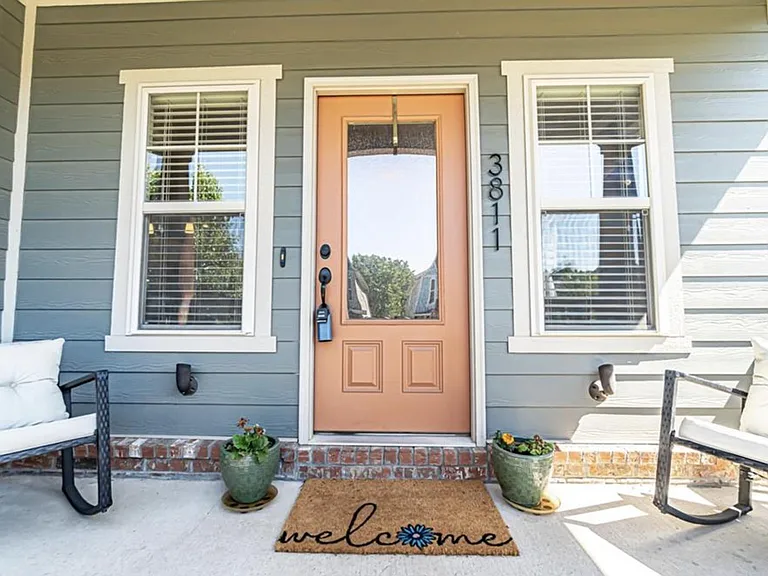 Front door leads into living space. Front porch has room for seating.