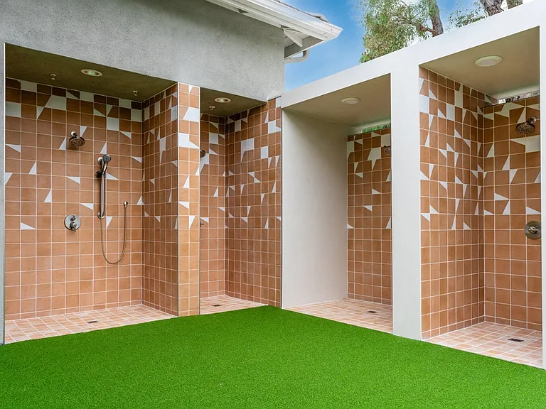 Outdoor Shower Stalls with Unique Patterned Tile and Overhead Lighting