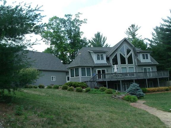 PEARL OF LAKE OGEMAW. HOME FEATURES APPROX 3800 SQ.FT. PLUS A BONUS ROOM OVER THE GARAGE FOR YOUR HOBBIES OR PRIVATE AREA FOR A BUNK ROOM. 4-CAR GARAGE HAS ROOM FOR A LARGE WORKSHOP OR JUST SEVERAL CARS. PAVED DRIVE FOR MORE PARKING.  THE BEACH IS PRIVATE AND IS IN A SMALL COVE JUST OFF THE MAIN LAKE. THE WATER IS DEEP BY THE TIME YOU GET TO THE END OF THE DOCK SO FISHERMAN, ENJOY YOURSELVES!!! 4 BEDROOMS AND 3.5 BATHS.  THE MASTER BATH HAS HEATED FLOORS WITH A JACUZZI E TUB AND MULTI HEAD SHOWER