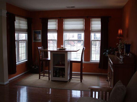 dining room has hardwood floors & lots of windows
