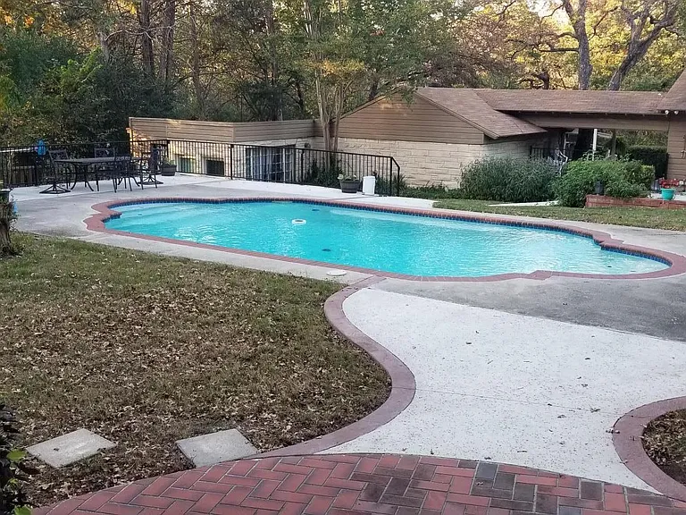 Fantastic pool deck. Bungalow pictured behind deck. New laundry machines located on right side of breezeway. Outside shower available. Pool has since been redone since this picture with the darker pebbles in other pictures.