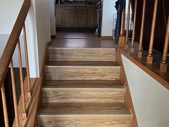 Stairs heading up from the front door to the kitchen.