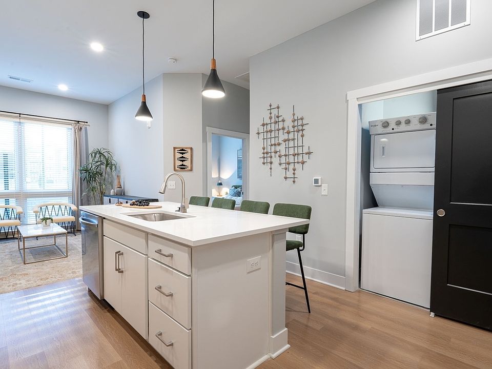 Quarry Trails Model washer/dryer, island kitchen and living room