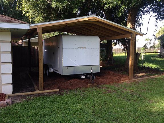 additional covered parking with shed in back yard