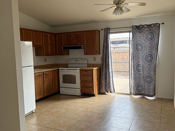 Kitchen/Dinning Area - Sliding Door to back Courtyard and Back Gate to Covered Carport with assigned Parking