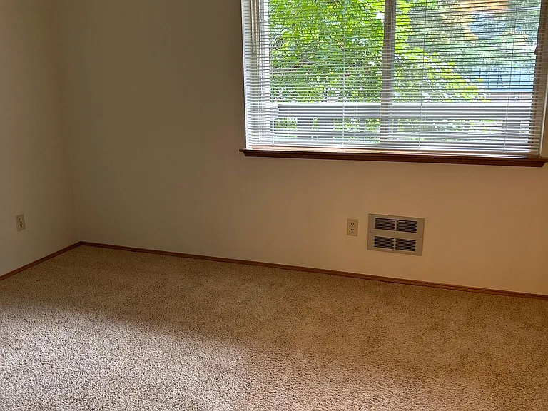 Main bedroom looking out to tree & private balcony.