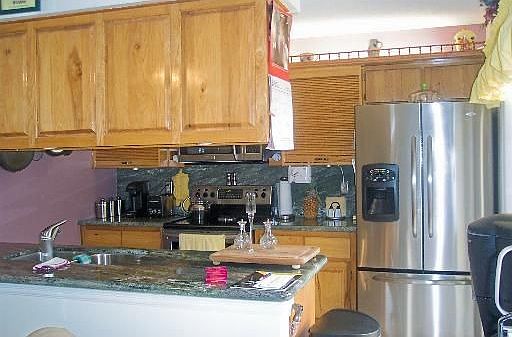 STAINLESS STEEL APPLIANCES AND WOOD CABINETS