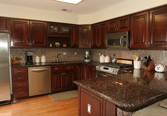 Cherry cabinets, stainless steel appliances and granite countertops