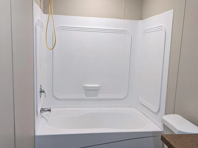 Primary suite bathroom shower with extra large tub