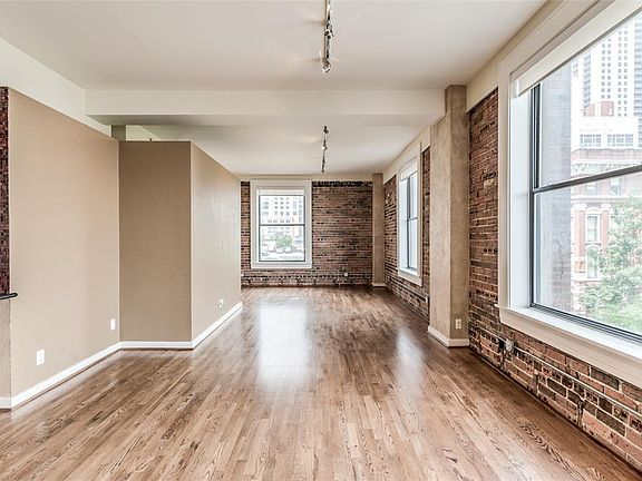 Large open Living/Dining room with fantastic skyline views! All windows have solar shades. At far left is alcove that is open Secondary Bedroom. Rent includes 24/7 concierge, gym, rooftop deck with splash pool, water, sewer, trash, gas, & building in