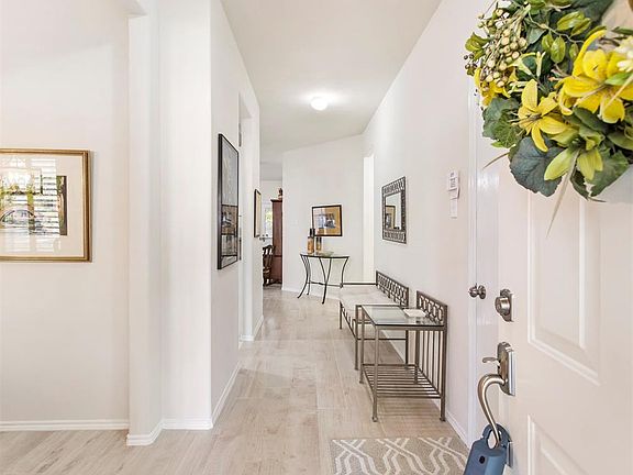 The inviting entry greets you as you enter the home. Notice the wood-look tile floors that flow throughout the living areas.