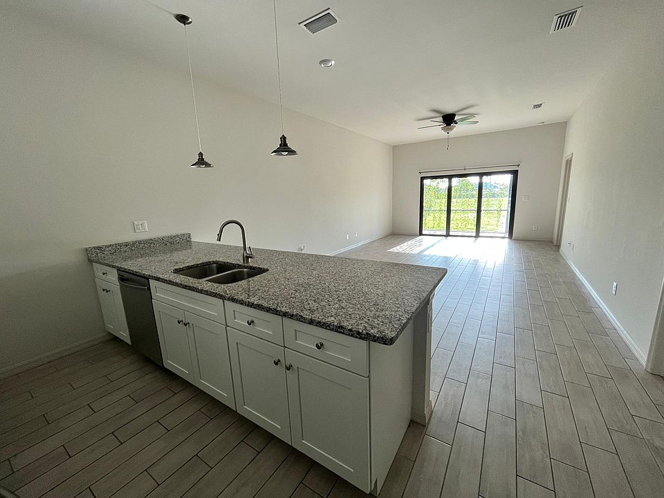 A grand open kitchen, living/family and dining room with 10' ceiling and 3 glass panels that slide in to one to create an indoor outdoor space.