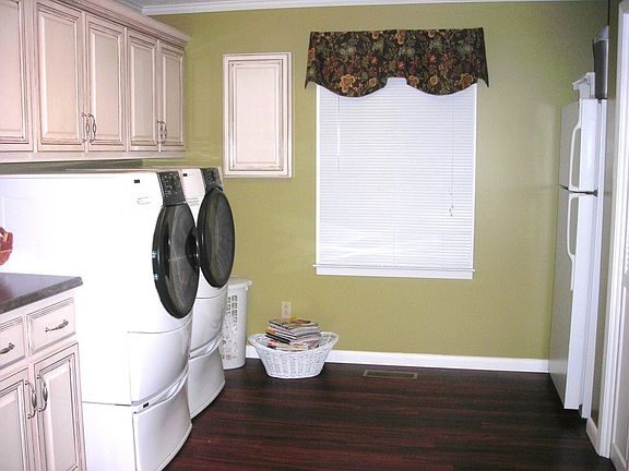 Remodeled Large Utility Room with Built-in Cabinets & Wood Floor