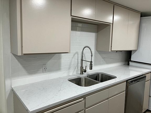 new faucet, new sink, new tile backsplash, beautiful quartz counter tops & brand new refrigerator, new canned lights.