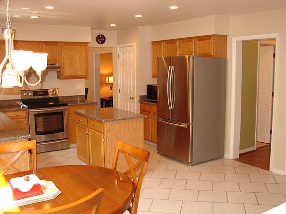 Kitchen features granite and recessed lighting