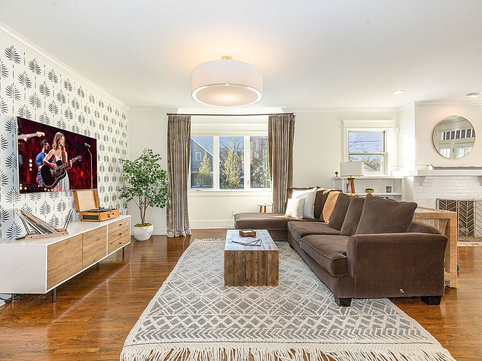 Open-concept living and dining area with hardwood floors and natural light throughout