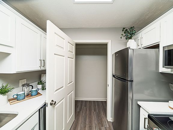 Kitchen with granite counters, modern cabinetry, and stainless appliances