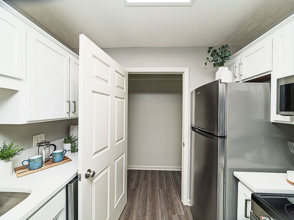 Kitchen with granite counters, modern cabinetry, and stainless appliances