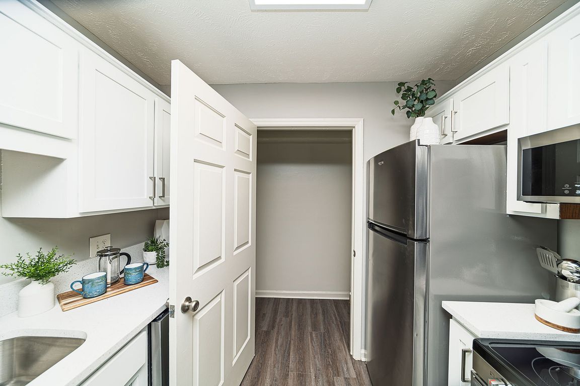 Kitchen with granite counters, modern cabinetry, and stainless appliances