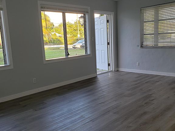 Living room showing entrance and all the windows.