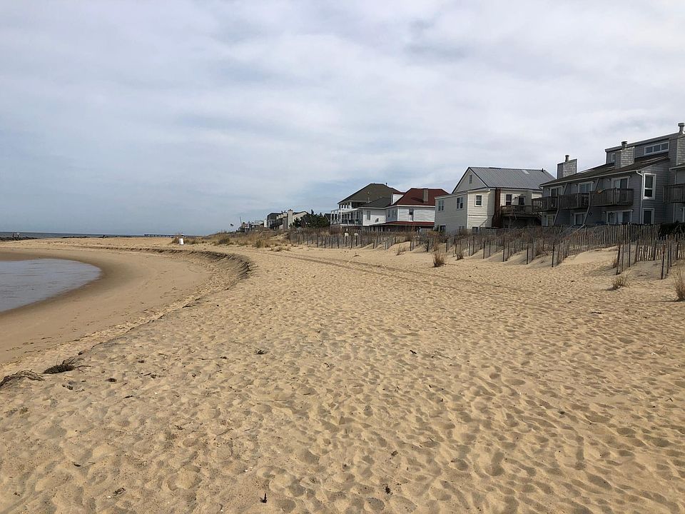 view of the house from the beach the house has gable roof