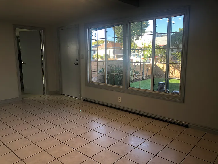 Living room facing front yard, driveway and street. Garage door to the left of main door entrance