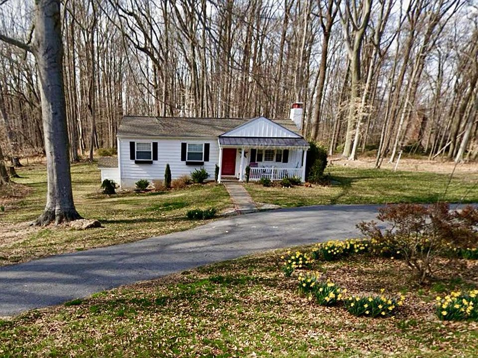 Additional lower floor entrance on left. Circular driveway. 3/4 acre lawn, 1 1/4 acre mature woods.