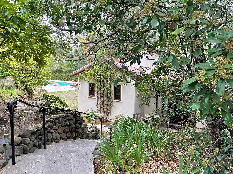 This private 2 bd/1ba house sits on the back corner of a 1.2 acre lot in Woodside.