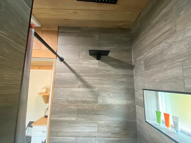 Indoor Shower has rain head and waterfall shower head.