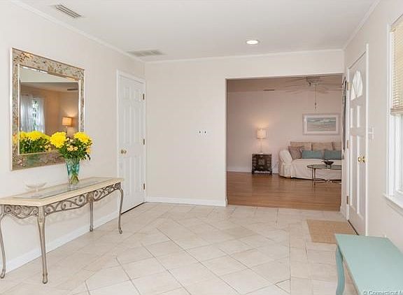 Entry way leads to both the formal living room, family room kitchen and lower level.